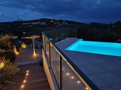 a swimming pool on the roof of a house at night at Villa Mekasteni in Cirendinu