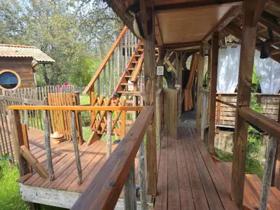 a wooden deck with a staircase in a house at GITES O FIL DE L'EAU piscine spa accès rivière in Omessa