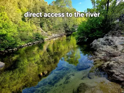 a river with the words direct access to the river at GITES O FIL DE L'EAU piscine spa accès rivière in Omessa