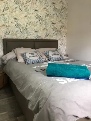 a bed with a blue bag on top of it at Butia in San-Giovanni