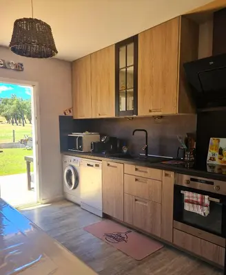 a kitchen with a sink and a washing machine at Butia in San-Giovanni