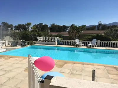 a large swimming pool with a pink balloon next to it at Butia in San-Giovanni