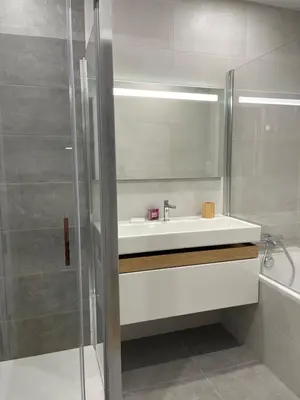 a bathroom with a white sink and a shower at Superbe appartement neuf de haut standing in Ajaccio
