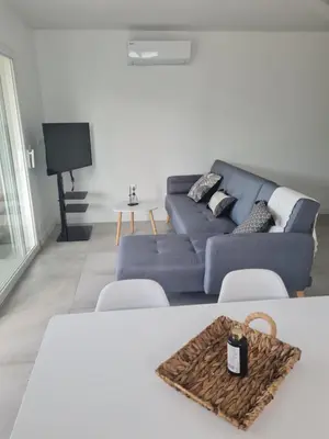 a living room with a blue couch and a table at Location 