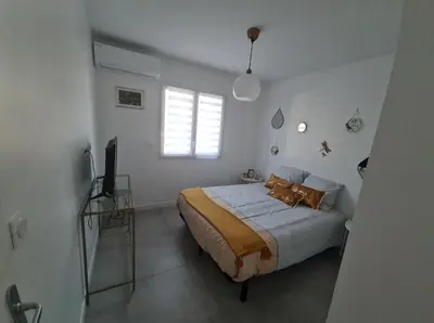 a bedroom with a bed and a television in it at Location 