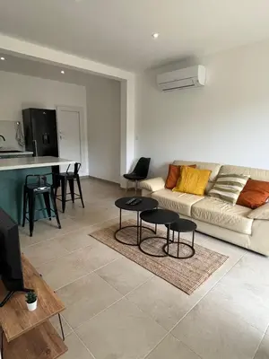 a living room with a couch and a table at Appartement Soveria in Soveria