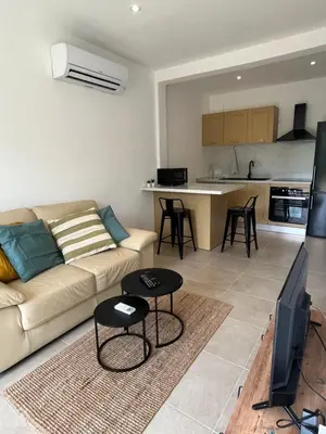 a living room with a couch and a kitchen at Appartement Soveria in Soveria