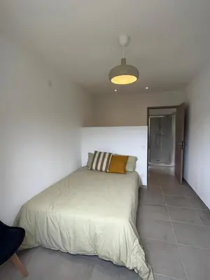 a bedroom with a bed in a white room at Appartement Soveria in Soveria