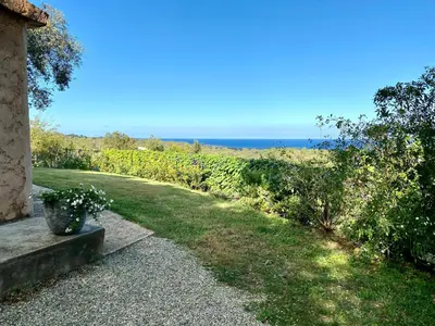 a garden with a view of the ocean at Domaine Punta della Guardia villa panorama maquis et mer, plage à 1,5 Km in Cervione