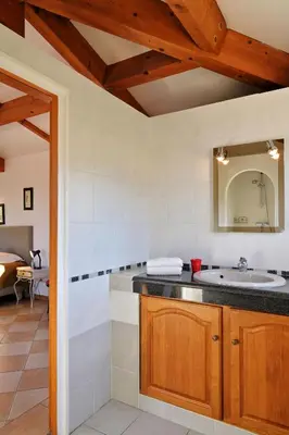 a bathroom with a sink and a mirror at Domaine Punta della Guardia villa vue mer dans nature protégée, plage à 1,5 km in Cervione