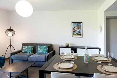a living room with a table and a couch at Domaine d'Arca Porto Vecchio - T2 - Rez de Jardin - 4 personnes 