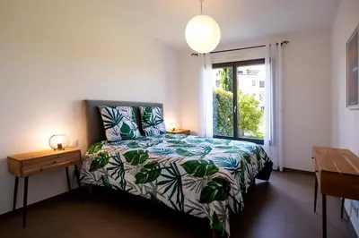 a bedroom with a bed and a window at Domaine d'Arca Porto Vecchio - T2 - Rez de Jardin - 4 personnes 
