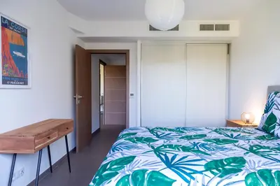 a bedroom with a bed and a wooden desk at Domaine d'Arca Porto Vecchio - T2 - Rez de Jardin - 4 personnes 