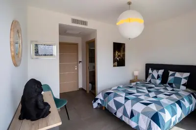 a bedroom with a bed and a teddy bear on a table at Domaine d'Arca - Hugo 13 - 6 pers in Porto-Vecchio