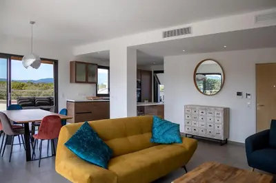a living room with a couch and a table at Domaine d'Arca - Hugo 13 - 6 pers in Porto-Vecchio