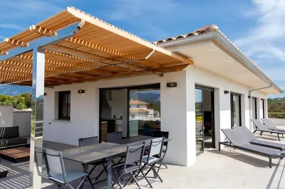 a patio with a wooden pergola and a table and chairs at Domaine d'Arca - Hugo 13 - 6 pers in Porto-Vecchio