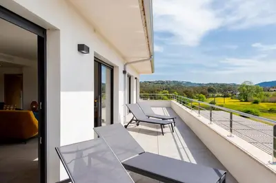 a balcony with chairs and a view of the countryside at Domaine d'Arca - Hugo 13 - 6 pers in Porto-Vecchio