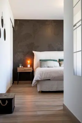 a bedroom with a bed and a table with a lamp at Domaine d'Arca - Hugo 09 - 6 pers - « Les Charmes » in Porto-Vecchio