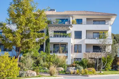 an apartment building with a garden in front of it at Domaine d'Arca - Hugo 09 - 6 pers - « Les Charmes » in Porto-Vecchio
