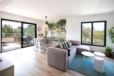 a living room with a couch and a table at Domaine d'Arca - Hugo 09 - 6 pers - « Les Charmes » in Porto-Vecchio