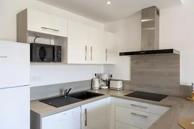 a white kitchen with a sink and a microwave at Résidence Domaine d'Arca Porto Vecchio - T2 haut standing - 4 personnes 