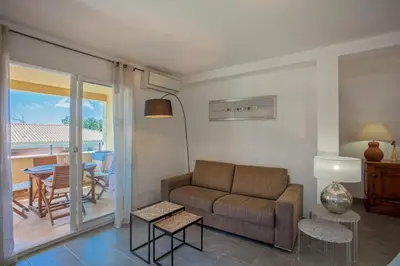a living room with a couch and a table at Casa Chjara Maria in Vescovato