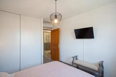 a bedroom with a bed and a tv on the wall at Casa Chjara Maria in Vescovato