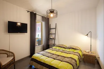 a bedroom with a bed and a tv on the wall at Casa Chjara Maria in Vescovato