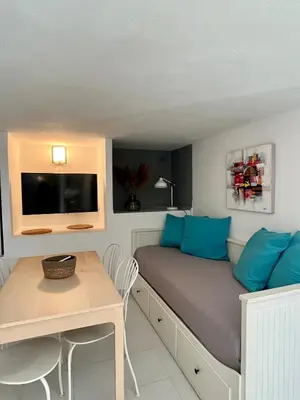 a bedroom with a bed and a large window at Résidence Storia di Blue in Porto-Vecchio