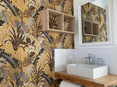 a bathroom with a sink and a yellow and blue wallpaper at Casa Santa Giulia in Propriano