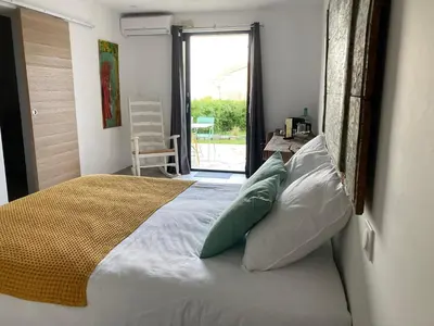 a bedroom with a bed with pillows and a window at Casa Santa Giulia in Propriano