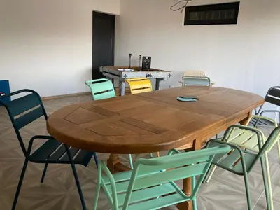 a wooden table and chairs in a room at Casa Santa Giulia in Propriano