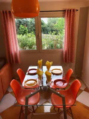 a dining room with a table and chairs and a window at Casa Mathilde in Lecci