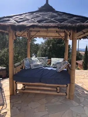 a bed under a gazebo on a patio at Casa Mathilde in Lecci