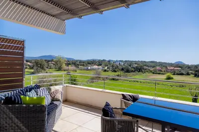 a patio with a table and chairs on a balcony at Domaine d'Arca - Eluard 10 - 3 pers in Porto-Vecchio