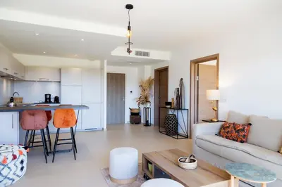 a living room with a couch and a table at Domaine d'Arca - Eluard 10 - 3 pers in Porto-Vecchio