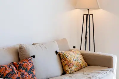 a white couch with two pillows and a lamp at Domaine d'Arca - Eluard 10 - 3 pers in Porto-Vecchio