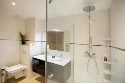 a bathroom with a shower and a toilet and a sink at Domaine d'Arca - Eluard 10 - 3 pers in Porto-Vecchio