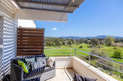 a balcony with a couch and a view at Domaine d'Arca - Eluard 10 - 3 pers in Porto-Vecchio