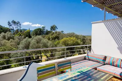 a balcony with a couch and chairs on a roof at Domaine d'Arca - Aragon 11 - 4 pers - « Au jardin d'Arca » in Porto-Vecchio