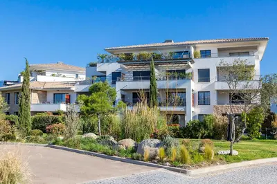 a large white building with a garden in front of it at Domaine d'Arca - Aragon 11 - 4 pers - « Au jardin d'Arca » in Porto-Vecchio