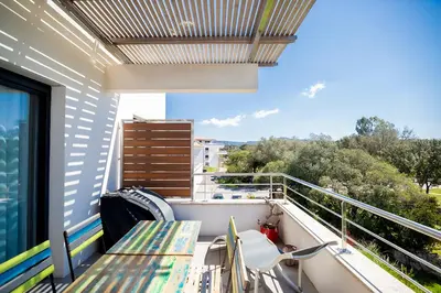 a balcony with a table and chairs on it at Domaine d'Arca - Aragon 11 - 4 pers - « Au jardin d'Arca » in Porto-Vecchio
