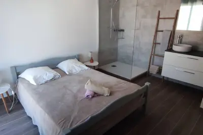 a bedroom with a bed with a stuffed animal on it at F4 à Porticcio avec piscine et vue sur mer in Porticcio