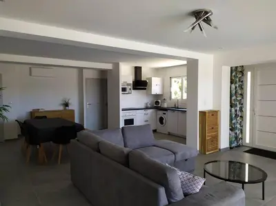 a living room with a couch and a table at F4 à Porticcio avec piscine et vue sur mer in Porticcio