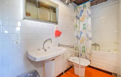 a bathroom with a sink and a toilet at 3 Bedroom Nice Home In Pietra Di Verde in Pietra-di-Verde