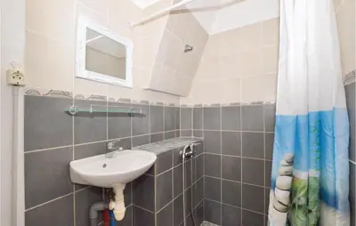 a bathroom with a sink and a mirror at Amazing Home In Aleria With Wifi in Aléria