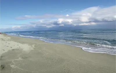 a beach with the ocean on a cloudy day at Amazing Home In Aleria With Wifi in Aléria