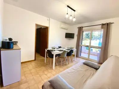 a kitchen and a dining room with a table and chairs at Les Roches de Figa in Conca