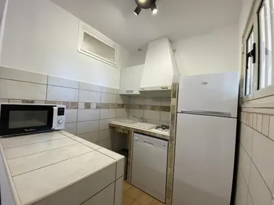 a kitchen with a white refrigerator and a microwave at Les Roches de Figa in Conca