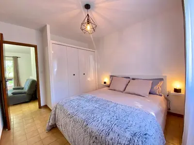 a bedroom with a large bed and a mirror at Les Roches de Figa in Conca